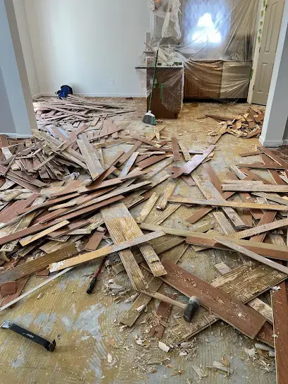 Water-damaged hardwood flooring pulled up during a Charlotte dry-out