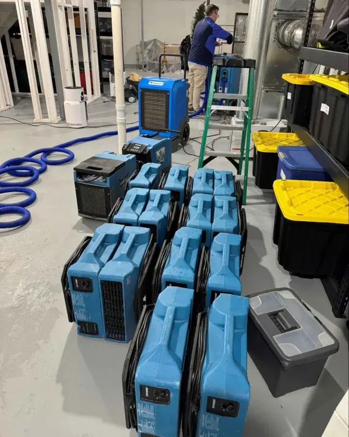 Dehumidifiers and air movers staged for a Charlotte water damage dry-out