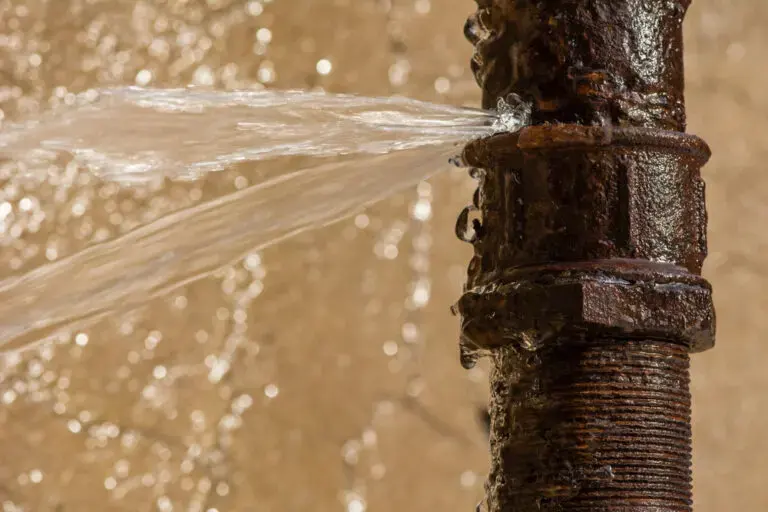 Water spraying from a split, corroded supply pipe